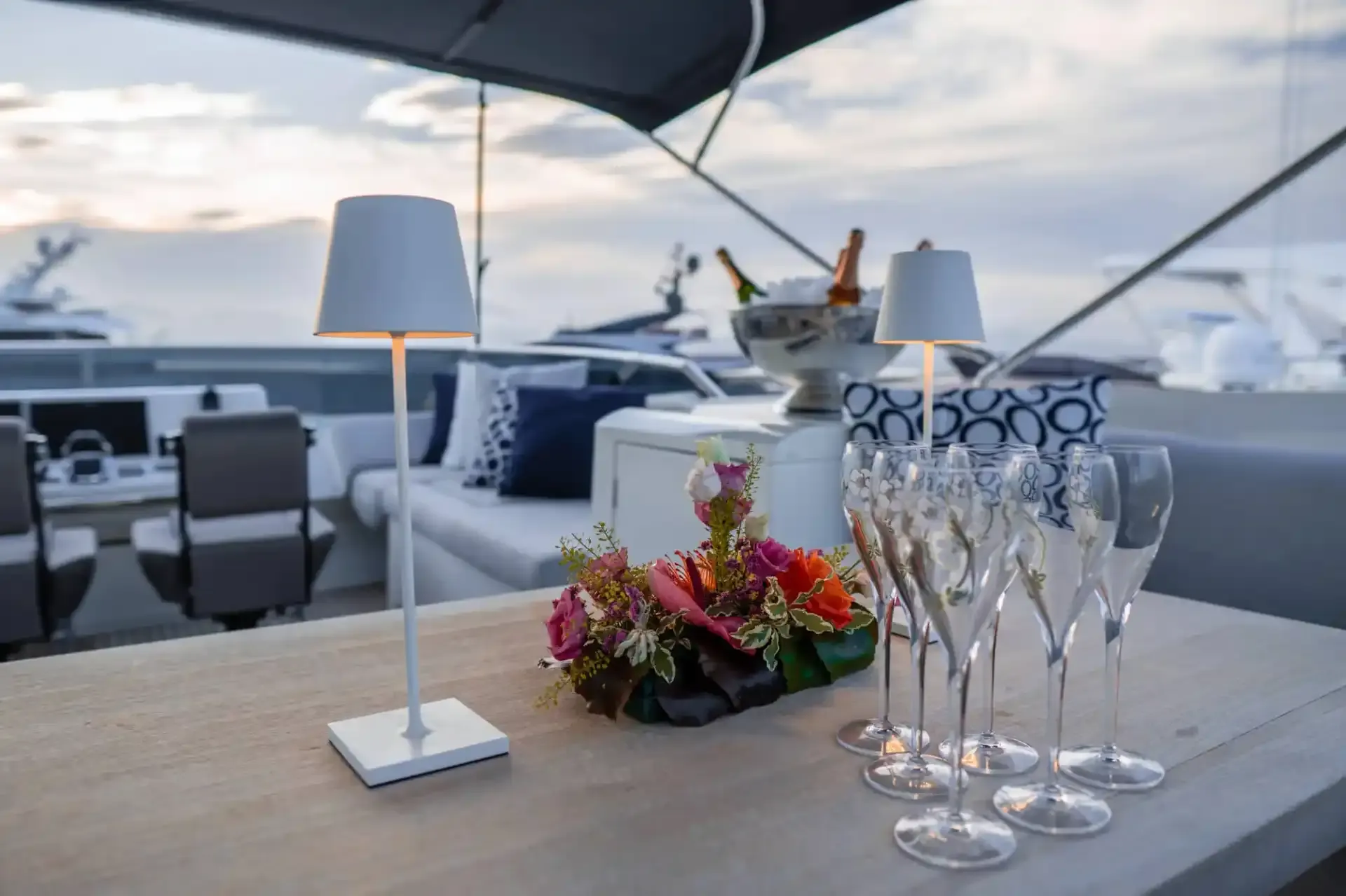 Champagne on ice, flutes and flowers on the flybridge of the yacht APOLLONIA at dusk
