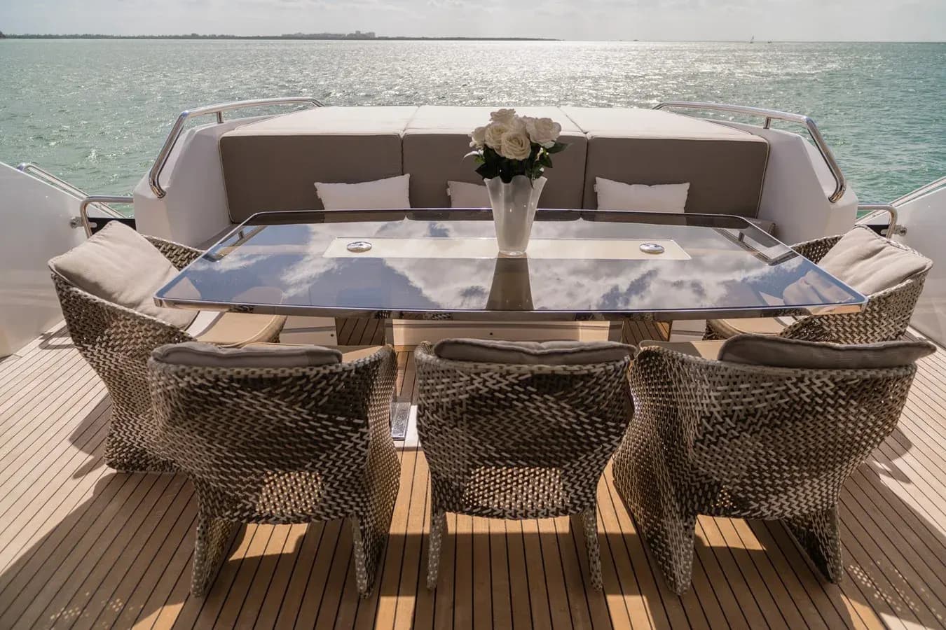Outdoor dining table on the aft deck of PEDDLER, a crewed yacht for a birthday yacht charter in the Bahamas